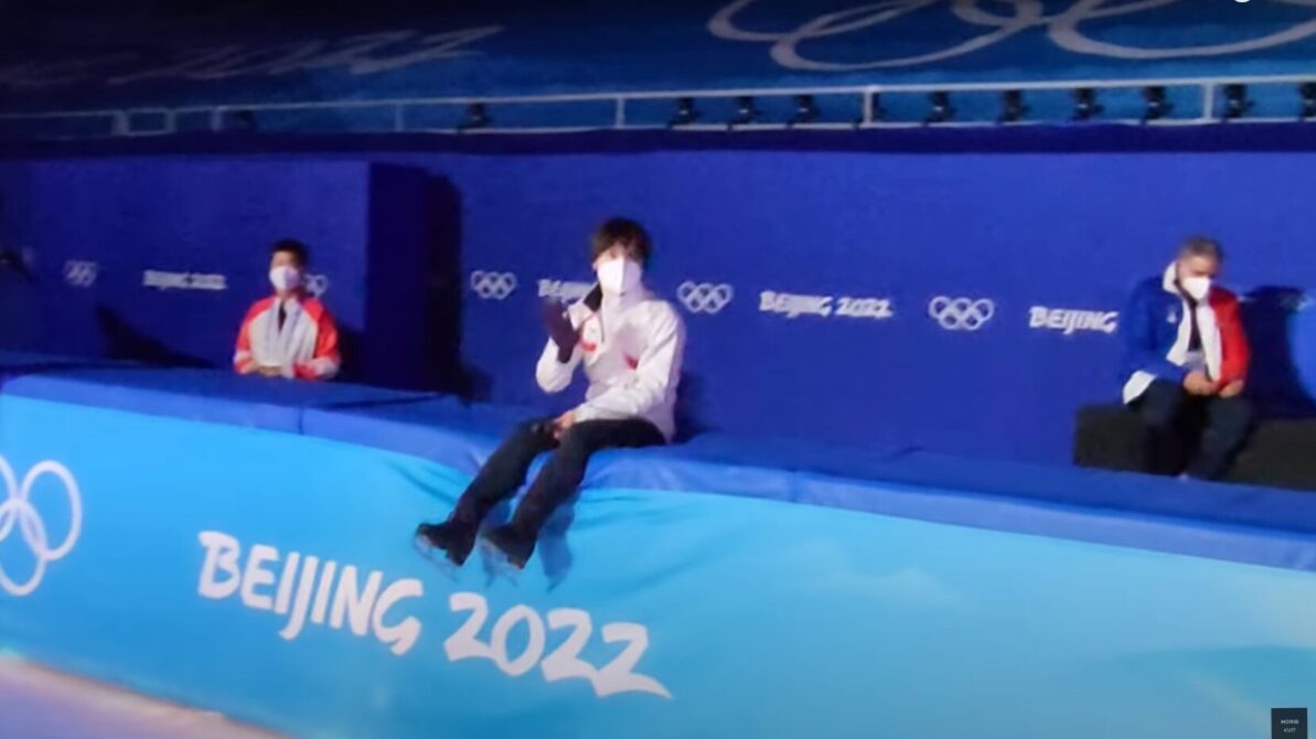 北京五輪のスケートリンクの壁の上にちょこんと腰掛けて手を振る宇野昌磨選手