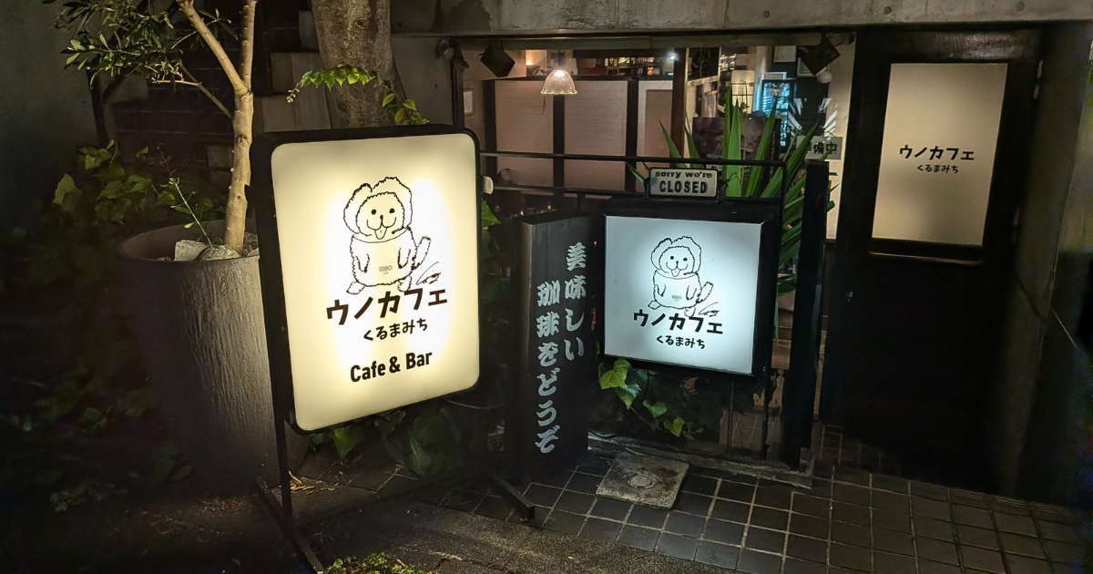 夜のUNO cafe くるまみち店の外観　可愛い看板が明るく光っている